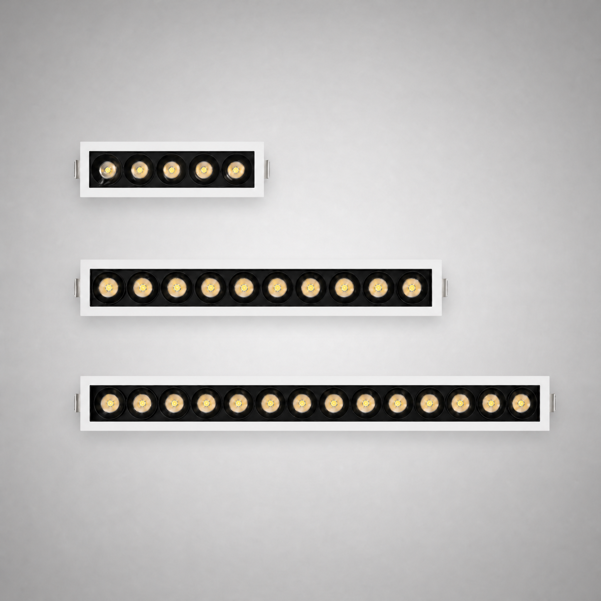 Architect Grille LED downlight series — comparison of short, medium and long fixtures in a staggered layout
