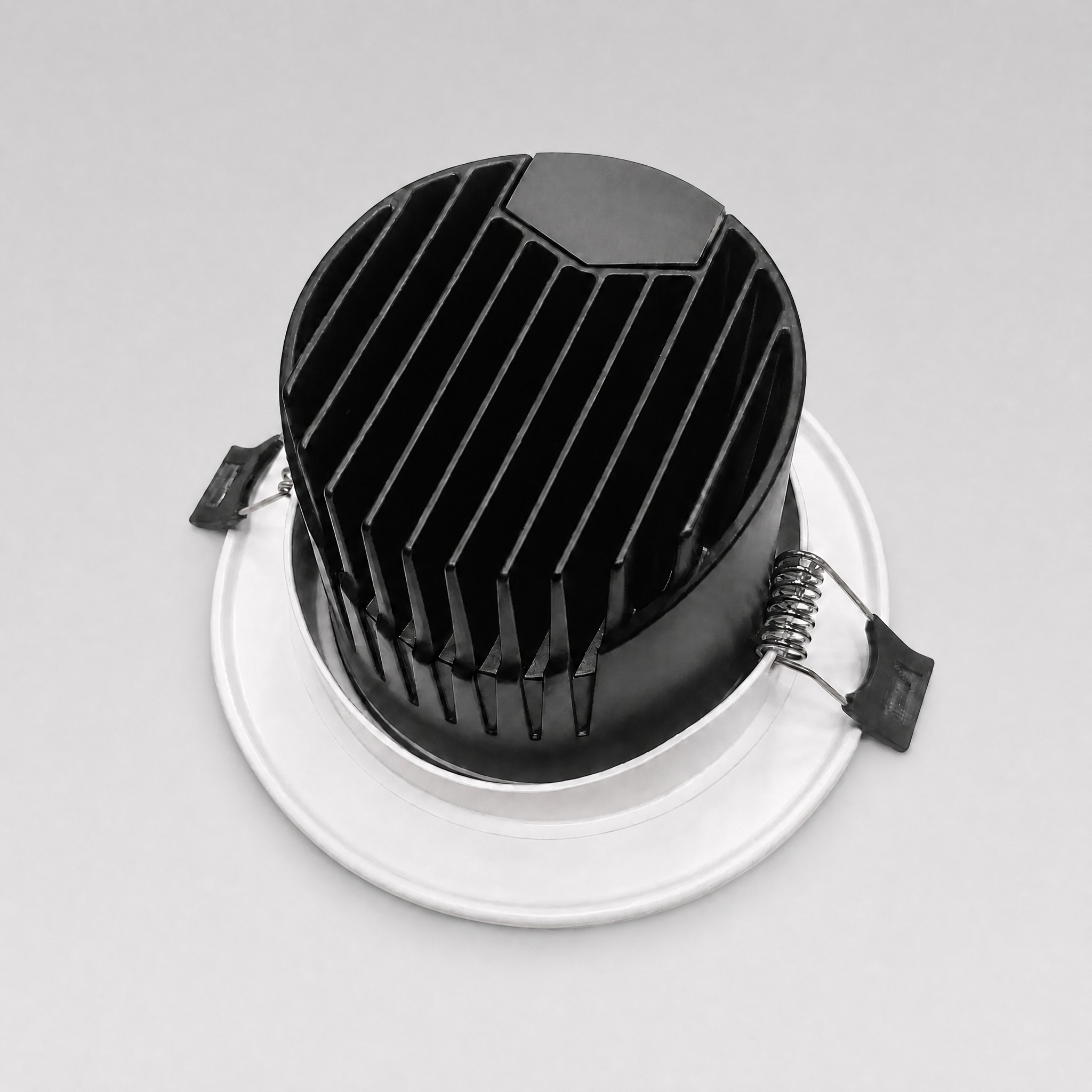 Essence Tri-CCT adjustable LED downlight — rear view showing the heat-sink housing and spring mounting clips